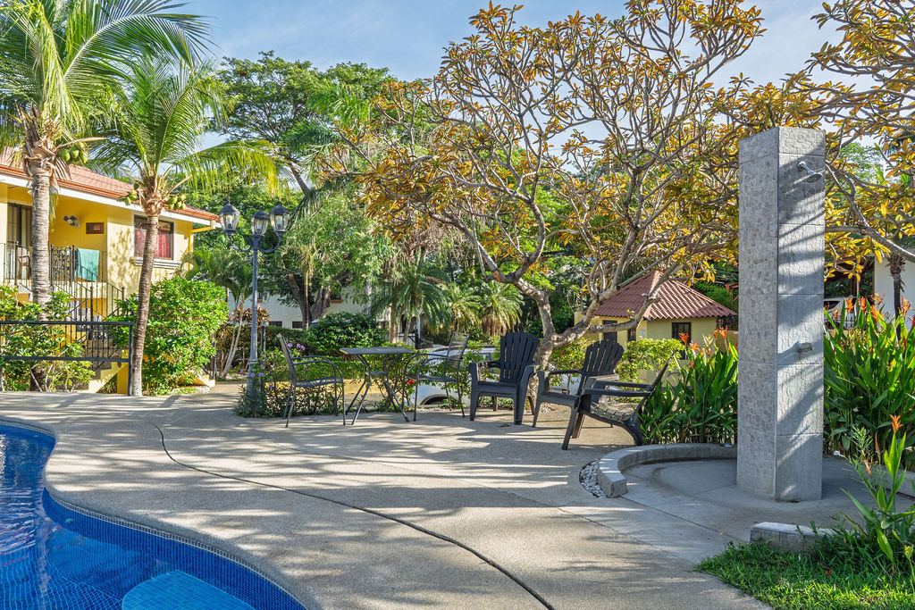 Pool deck with outdoor shower and cafe table