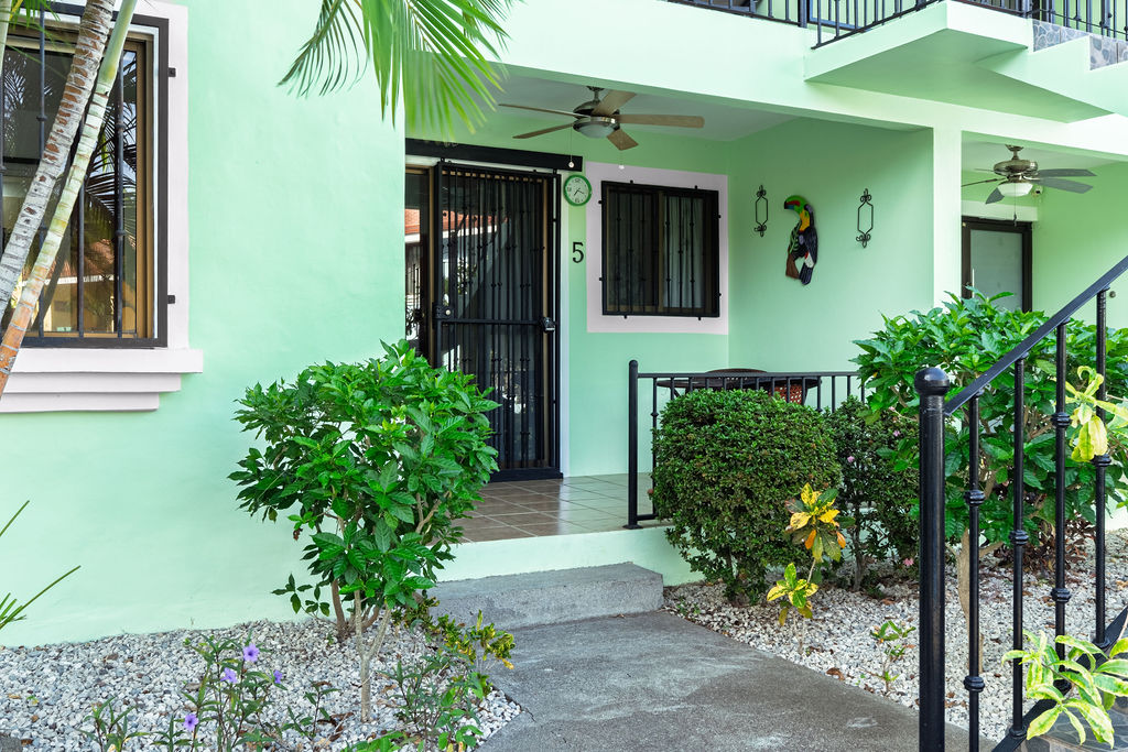 Front door of unit 5 with toucan art beside it